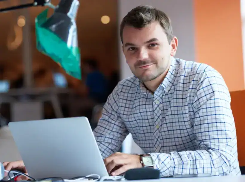 MSP owner reviewing triage plan on laptop, representing MSP Pipeline Triage™ to stop lead bleed and grow qualified leads